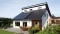 The picture shows photovoltaics on the roof of a detached house.