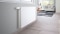 The picture shows a radiator in a living room with a ViCare thermostat for convenient individual room control.