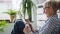 The picture shows a woman with grey hair and a tablet in her hands to represent the control of Viessmann ViCare components via app.
