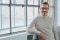 The picture shows a man with grey hair and glasses as a possible user of Viessmann ViCare components.